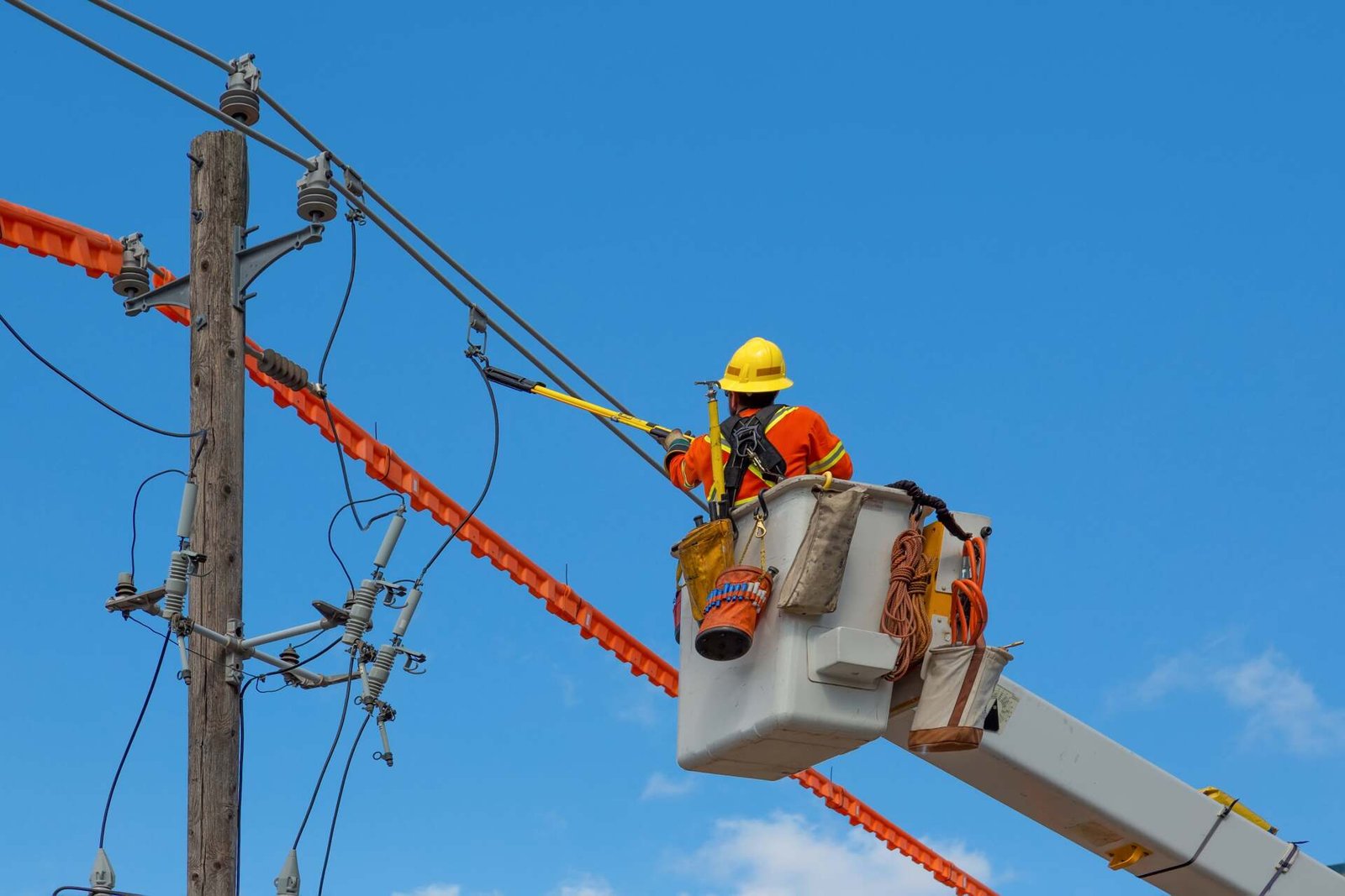 Worker performing power pole setting near me by South Florida Pole Setters and Crane Service, Inc.