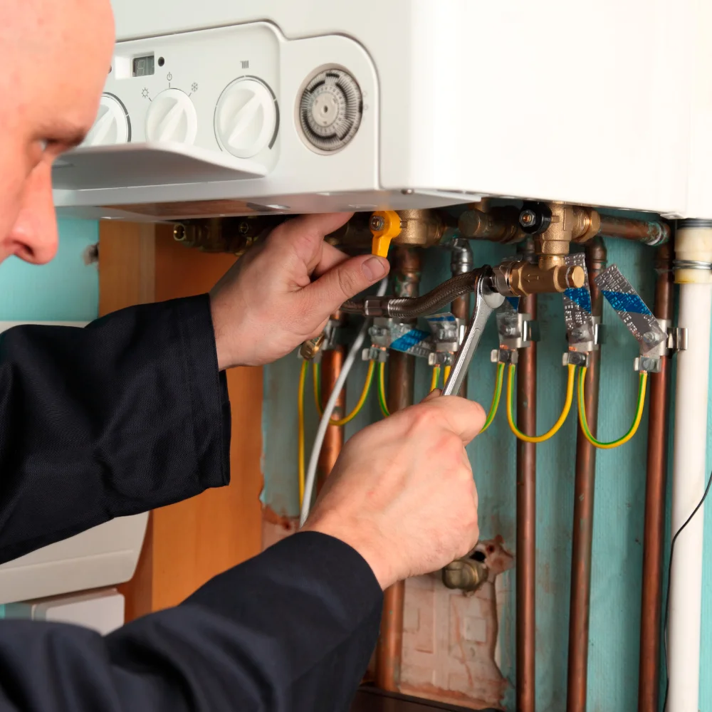 Technician performing detailed boiler repair colorado inside a home